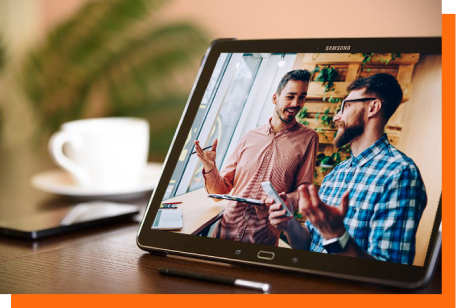 two men discussing markting on laptop screen