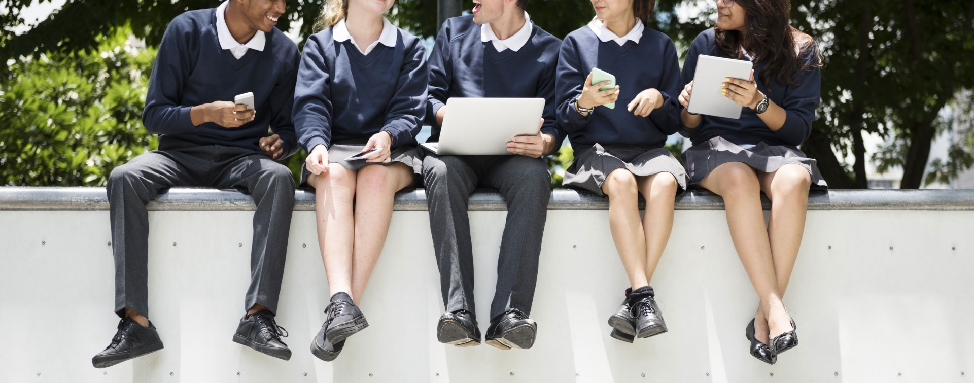 school kids sitting on wall